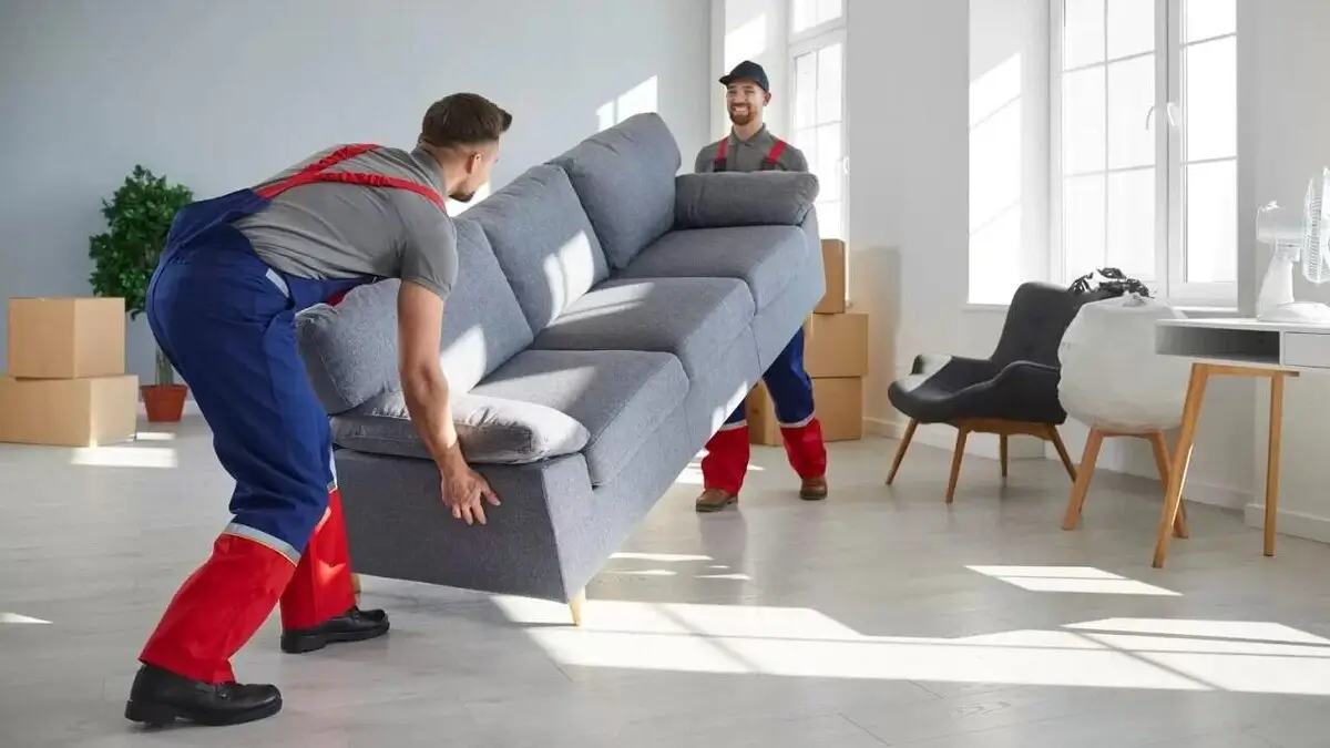 Professional mover carefully wrapping a piece of furniture