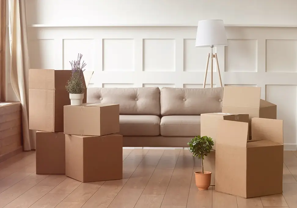 A bright and airy living room with packed boxes.